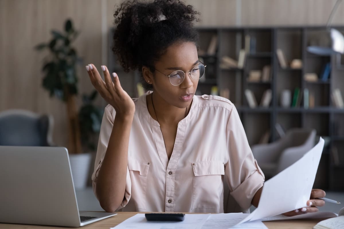 woman looking at paper asking tax questions for her small business