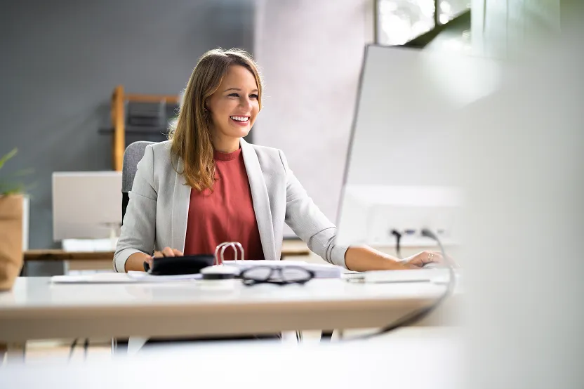 Woman in Red Shirt at Desktop