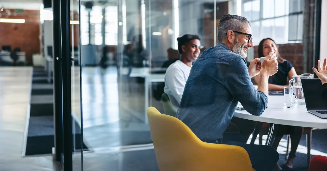 cheerful mature businessman attending a meeting