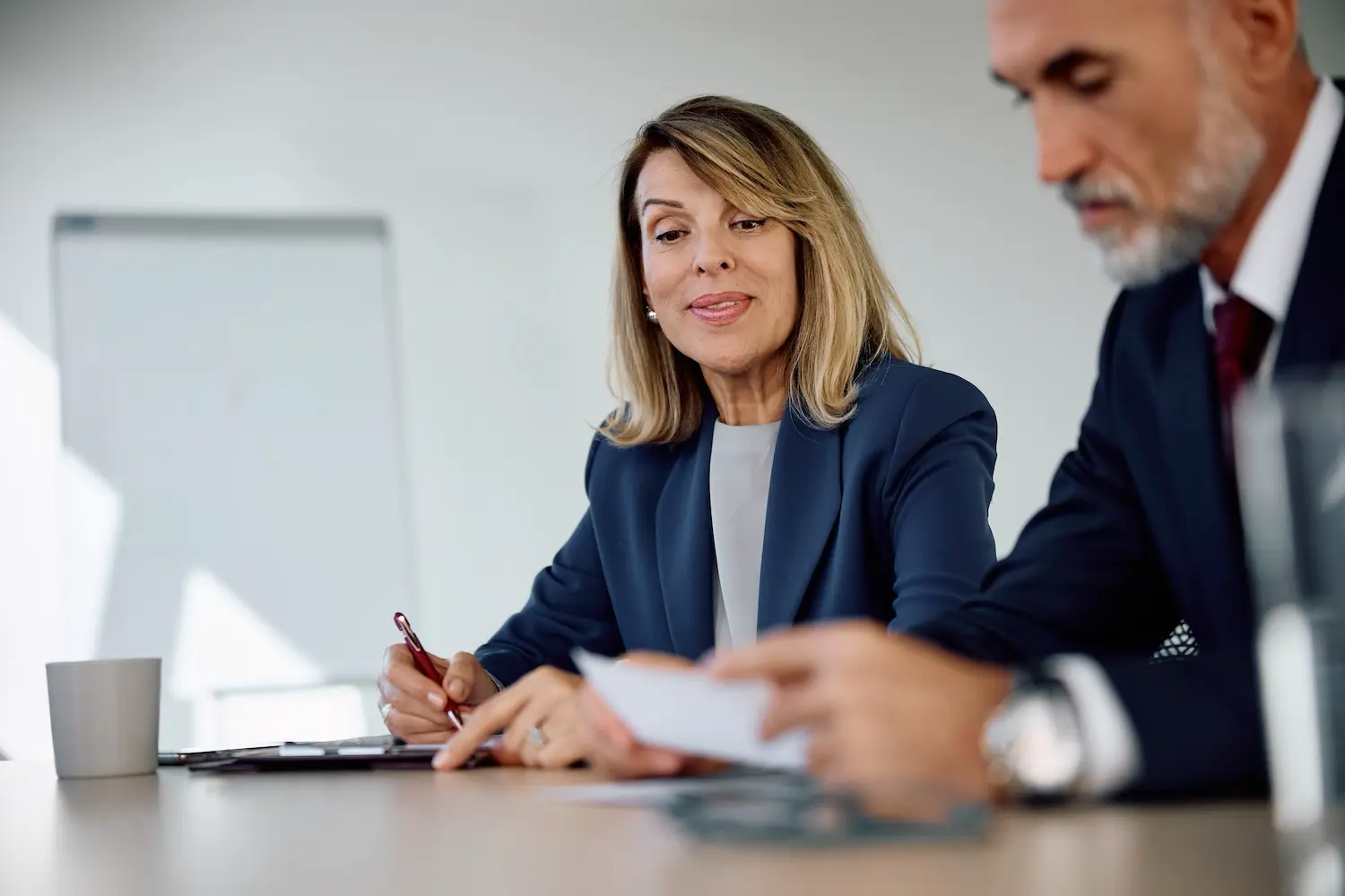 What Is an S Corp and When Should Your Business Make the Switch? 3 Small business owner discusses with her tax advisor the process for switching her company to an S corporation