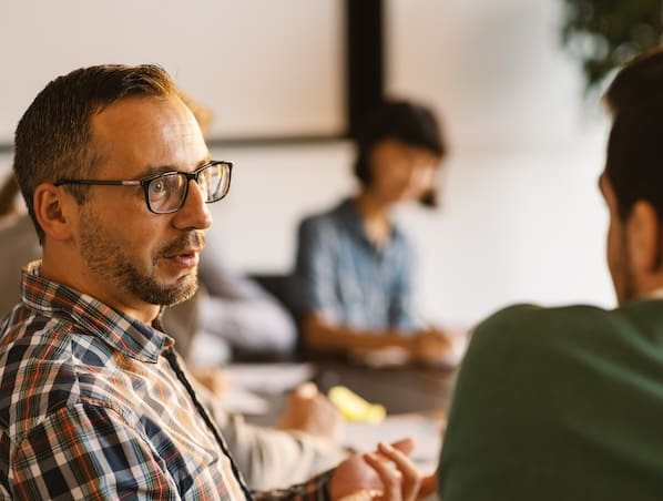 Man discussing construction accounting services in team meeting