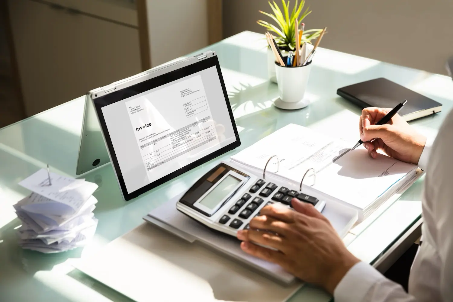 The Benefits and Risks of Invoice Factoring for Small Businesses 2 A small business owner reviews their invoices for factoring