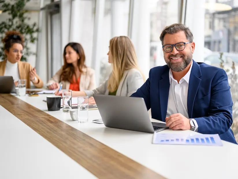 A SaaS fractional CFO reviews forecast models with company leaders