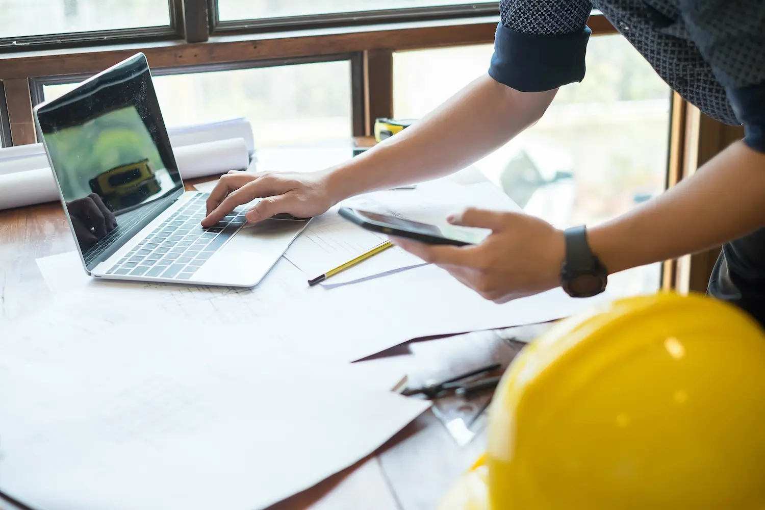 A construction manager reviews his project forecast.